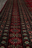 Load image into Gallery viewer, A close-up view of a traditional patterned rug with horizontal bands of red, black, beige, and turquoise geometric motifs.