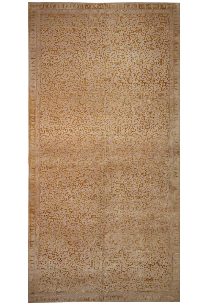 A rectangular area rug with an intricate traditional floral pattern in shades of beige, tan, and light brown, shown flat against a white background.