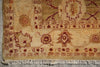 Load image into Gallery viewer, Close-up of a traditional patterned rug corner showing cream, tan, and rust-red motifs with fringe along the bottom edge.