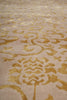 Load image into Gallery viewer, Close-up of a beige or cream textured surface with an ornate metallic gold damask pattern.