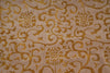 Load image into Gallery viewer, A close-up of a woven fabric with a repeating damask pattern in warm gold on a light beige background.