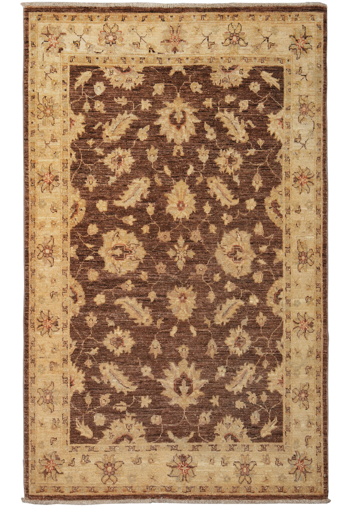 A traditional oriental-style area rug with a dark brown central field and a beige border featuring floral motifs.