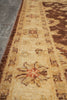 Load image into Gallery viewer, Close-up of a woven rug or textile with a beige and brown patterned border featuring floral motifs and repeating geometric details.