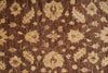 Load image into Gallery viewer, A close-up of a traditional patterned rug with a dark brown background and cream floral motifs.