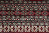 Load image into Gallery viewer, A close-up of a patterned rug with horizontal bands of geometric and floral motifs in red, black, beige, and light blue.