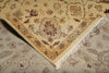 Load image into Gallery viewer, A close-up of a patterned area rug corner with cream and tan tones, floral motifs, and white fringe, laid over another matching rug.