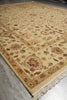Load image into Gallery viewer, A traditional oriental area rug with an intricate floral and medallion pattern in beige, brown, and muted red tones, shown laid out on a gray tiled floor.