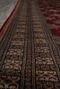 Load image into Gallery viewer, A close-up of a patterned rug with horizontal bands of black, beige, and red geometric motifs.