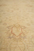 Load image into Gallery viewer, A close-up view of a light beige area rug with a faded, distressed traditional pattern in muted rust red and gray tones.