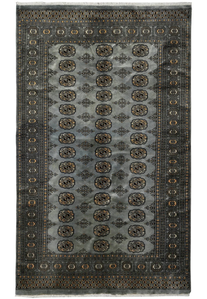 A rectangular area rug with a traditional Persian-style design, featuring a central field of muted gray with repeating circular medallions and a dark border.