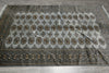 Load image into Gallery viewer, A large rectangular area rug with a light gray field, detailed medallion motifs, and a dark border, laid flat on a gray tiled floor.