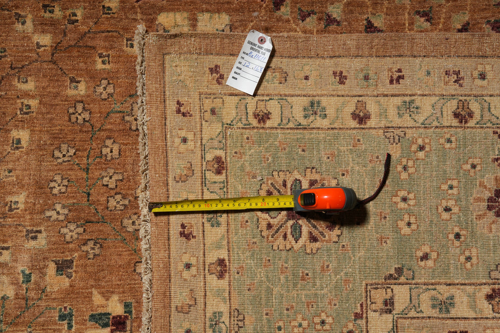 A close-up of a patterned area rug with a tape measure and price tag laid on top to show dimensions and condition.