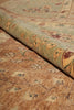 Load image into Gallery viewer, A close-up of a rolled section of a traditional patterned rug showing its beige and green base with floral motifs.