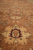 Load image into Gallery viewer, A close-up view of a traditional patterned area rug with a warm brown and beige base, featuring central medallions and floral motifs in rust red, cream, and muted green.