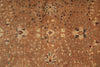 Load image into Gallery viewer, A close-up of an antique-style oriental rug with a warm brown and beige base, featuring intricate floral motifs and small geometric accents in muted blue, green, and burgundy.