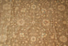 Load image into Gallery viewer, A close-up of a traditional patterned rug with a warm brown base, beige floral motifs, and light blue accents.