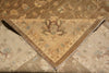 Load image into Gallery viewer, A close-up of a folded vintage-style area rug showing its intricate floral and geometric patterns in warm beige, brown, and muted blue tones.