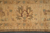 Load image into Gallery viewer, A close-up of an antique-style rug with a warm beige background, featuring a central floral motif in muted brown, red, and teal, and decorative borders.
