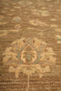 Load image into Gallery viewer, A close-up of a traditional patterned rug with a central floral medallion in beige, brown, and muted blue-green tones.
