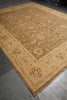 Load image into Gallery viewer, A large traditional area rug with a warm tan and beige base, featuring a central medallion pattern and a decorative border in muted brown, green, and cream tones, laid out on a gray stone floor.