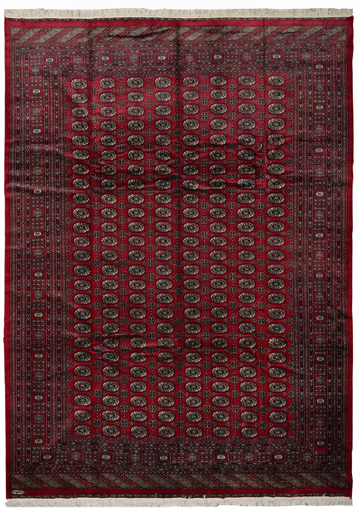 A traditional oriental area rug with a deep red field, intricate dark brown and black geometric patterns, and a matching red border with white fringe on the top and bottom.