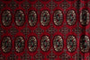 Load image into Gallery viewer, A close-up of a red patterned textile or rug with repeating ornate medallion motifs in beige, black, and dark red.