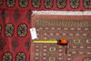 Load image into Gallery viewer, A red patterned area rug with white fringe and a detailed geometric border, shown with a yellow tape measure and a product tag on a matching red rug background.