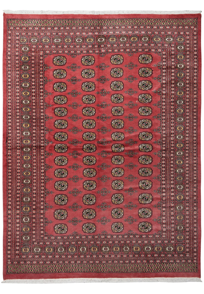 A traditional oriental area rug with a red field, featuring a central pattern of repeating medallions and a detailed multi-colored border.
