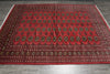 Load image into Gallery viewer, A large red Persian-style area rug with intricate black, gold, and beige geometric patterns, laid out on a gray tiled floor.