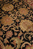 Load image into Gallery viewer, Close-up of an ornate floral rug pattern with large chrysanthemum-like flowers and scrolling vines on a black background, in gold, beige, and muted red tones.