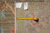 Load image into Gallery viewer, A close-up of a patterned area rug with a measuring tape laid across it and two inventory tags attached near the top edge, showing the rug's dimensions.