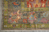 Load image into Gallery viewer, A close-up of a traditional patterned rug corner showing a muted olive green border, a gray-brown field, and floral motifs in rust red, dusty blue, lavender, and peach.