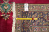 Load image into Gallery viewer, An ornate patterned area rug with cream fringe, shown with a yellow tape measure and a white inventory tag.