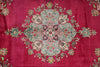 Load image into Gallery viewer, A close-up of a traditional patterned rug featuring a large central medallion in light blue, pink, and green, surrounded by a rich magenta-pink field with floral motifs.