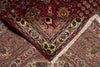Load image into Gallery viewer, A close-up of a traditional patterned rug corner showing a deep red field, a beige and burgundy geometric border, cream fringe, and additional matching rug sections underneath.