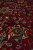 Load image into Gallery viewer, A close-up view of a traditional patterned rug with a deep red background and intricate floral motifs in beige, blue, green, and brown.