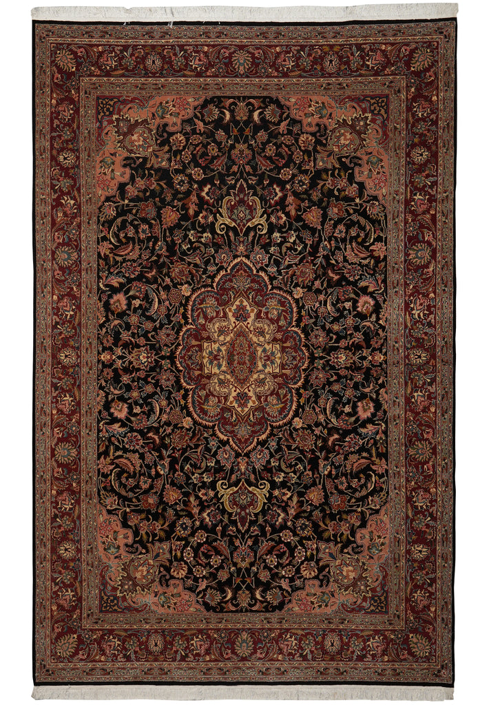 A traditional oriental area rug with an intricate floral and scroll pattern, featuring a dark central medallion, red and brown borders, and cream fringe on the top and bottom.
