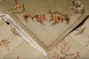 Load image into Gallery viewer, A close-up of a beige woven textile with a floral pattern in muted pink, brown, and green tones, finished with white fringe along one corner.