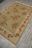 Load image into Gallery viewer, A rectangular area rug with a beige center and border, decorated with a traditional floral pattern in muted orange, brown, and cream tones, shown on a gray wood-look floor.
