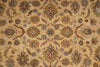 Load image into Gallery viewer, A close-up of an ornate patterned rug or textile with a warm beige background and repeating floral motifs in muted blue, brown, olive green, and rust tones.