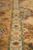 Load image into Gallery viewer, Close-up of a traditional patterned rug with a warm beige and gold base, featuring blue, red, and cream floral motifs.