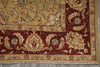 Load image into Gallery viewer, A close-up of an ornate traditional rug corner showing a deep red border with cream and beige floral motifs, a central beige field, and a patterned inner border.