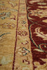 Load image into Gallery viewer, Close-up of a patterned rug with a warm beige background, a dark red border, and cream floral motifs with small teal accents.