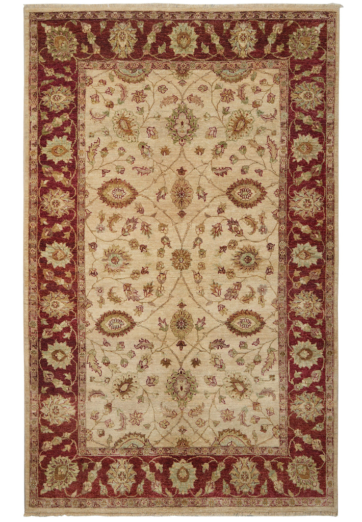 A traditional oriental-style area rug with an intricate floral pattern, featuring a cream center field, deep red borders, and beige accents.