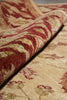 Load image into Gallery viewer, A close-up of a patterned area rug with a rolled section showing its red, beige, and green woven design.