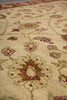 Load image into Gallery viewer, Close-up of a traditional patterned area rug with a cream base and floral motifs in muted red, green, and brown tones.