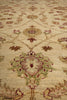 Load image into Gallery viewer, A close-up view of an ornate area rug with a traditional floral and medallion pattern in beige, muted green, and dusty rose tones.