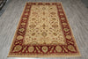 Load image into Gallery viewer, A rectangular traditional area rug with an ornate floral pattern, featuring a beige center field, deep red borders, and gold accents, laid out on a gray wood-look floor.