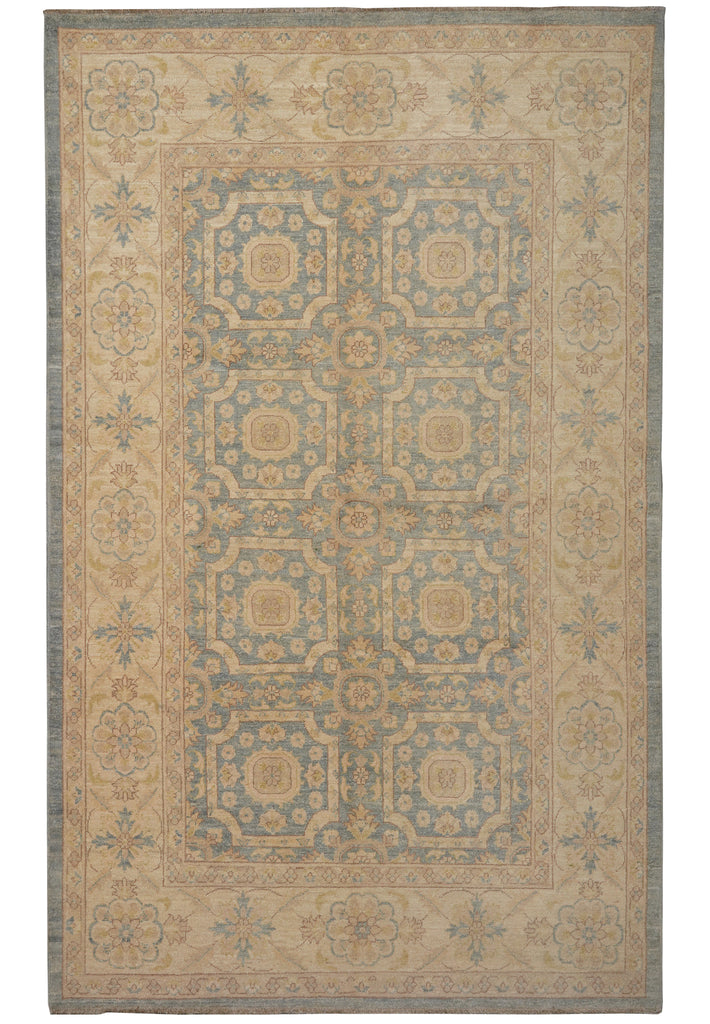 A rectangular traditional area rug with an ornate medallion pattern in beige, muted blue, and tan, shown flat against a white background.