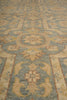 Load image into Gallery viewer, A close-up view of a traditional patterned area rug with a muted blue-gray and beige design.
